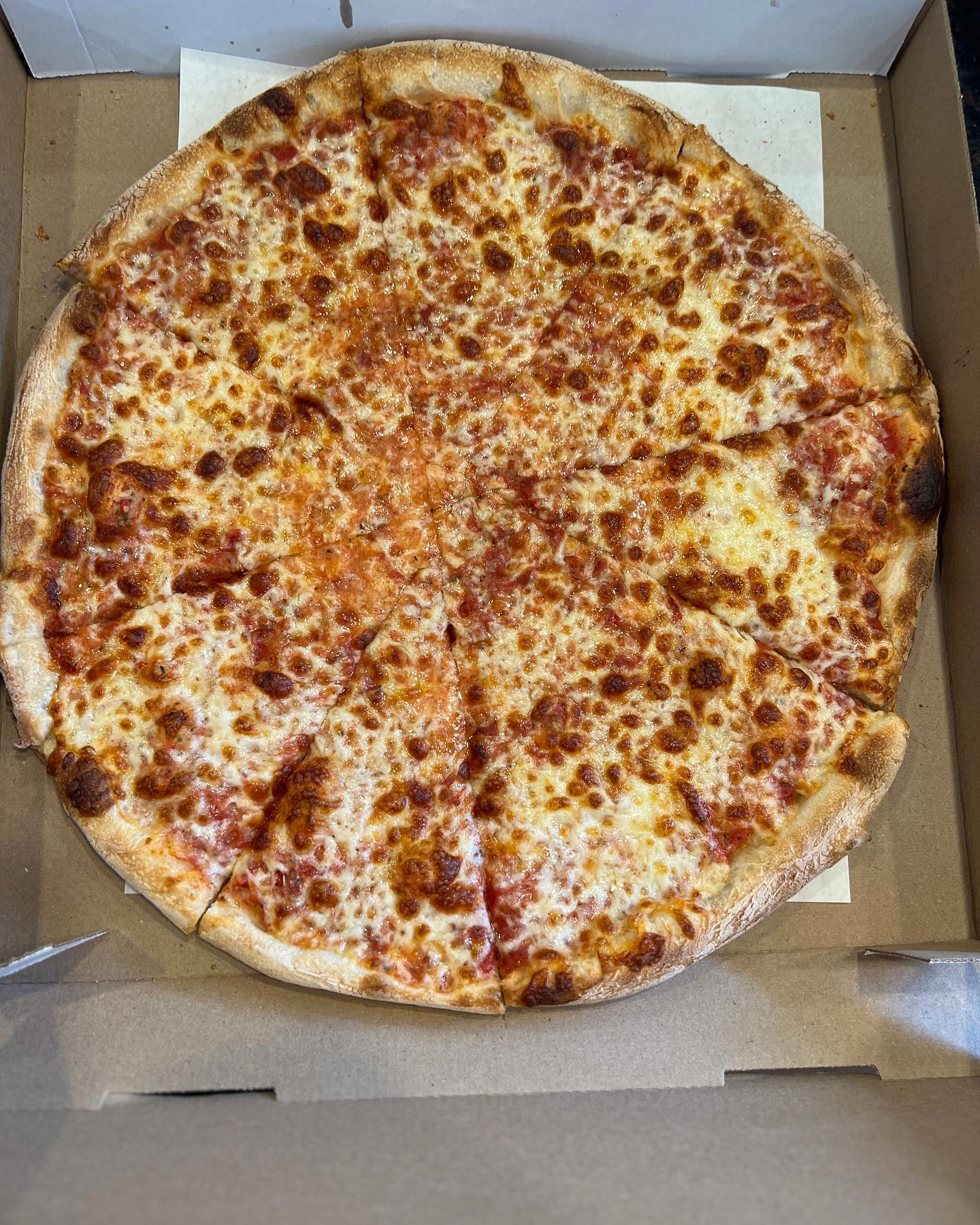 Fresh cheese pizza from Villa Pizza in a delivery box
